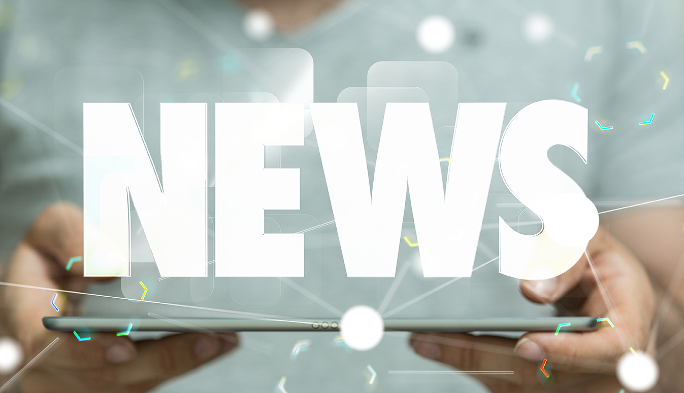 Close up of hands holding a tablet with the word "News" displayed over it.