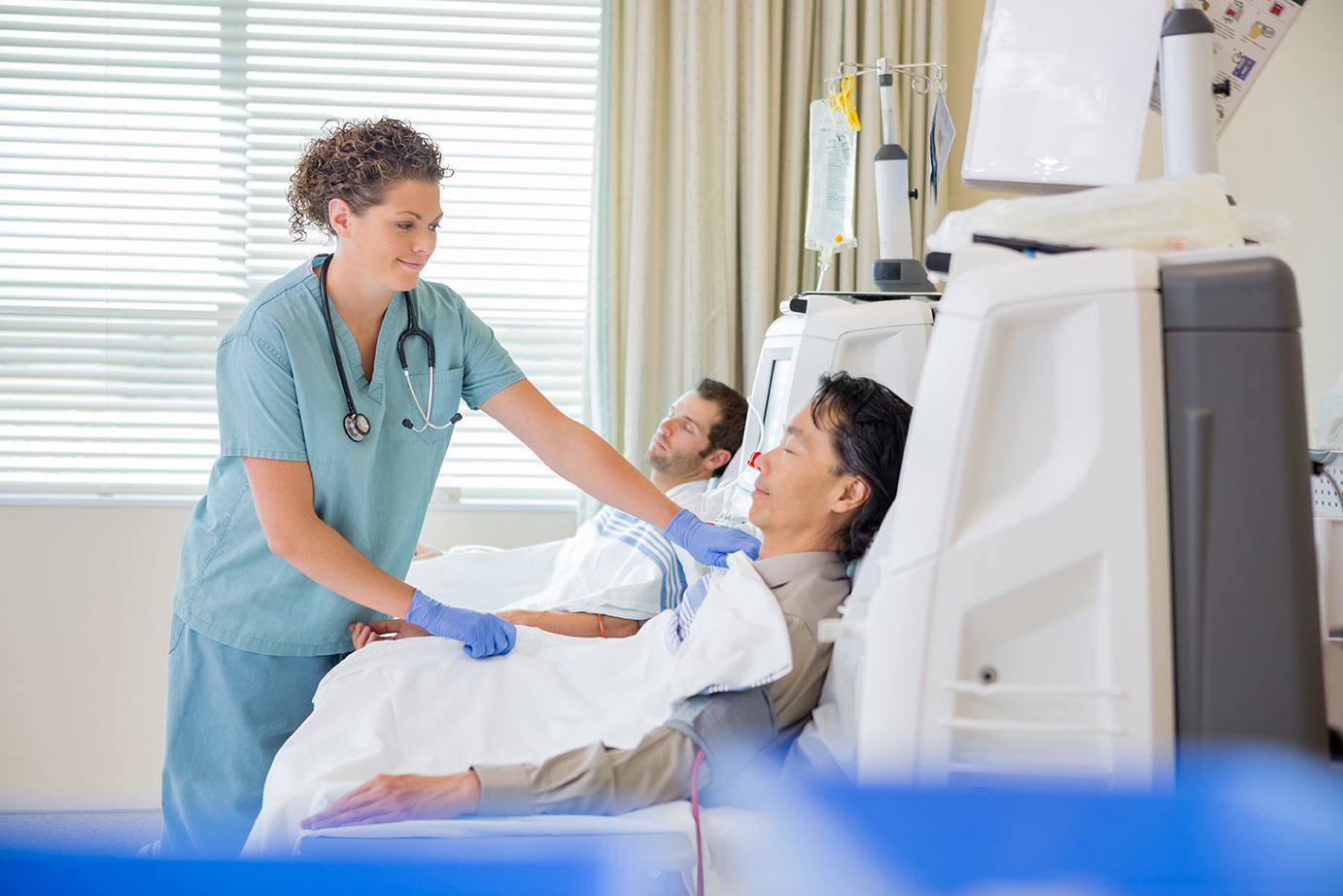 Nurse Assisting Patient Undergoing Renal Dialysis