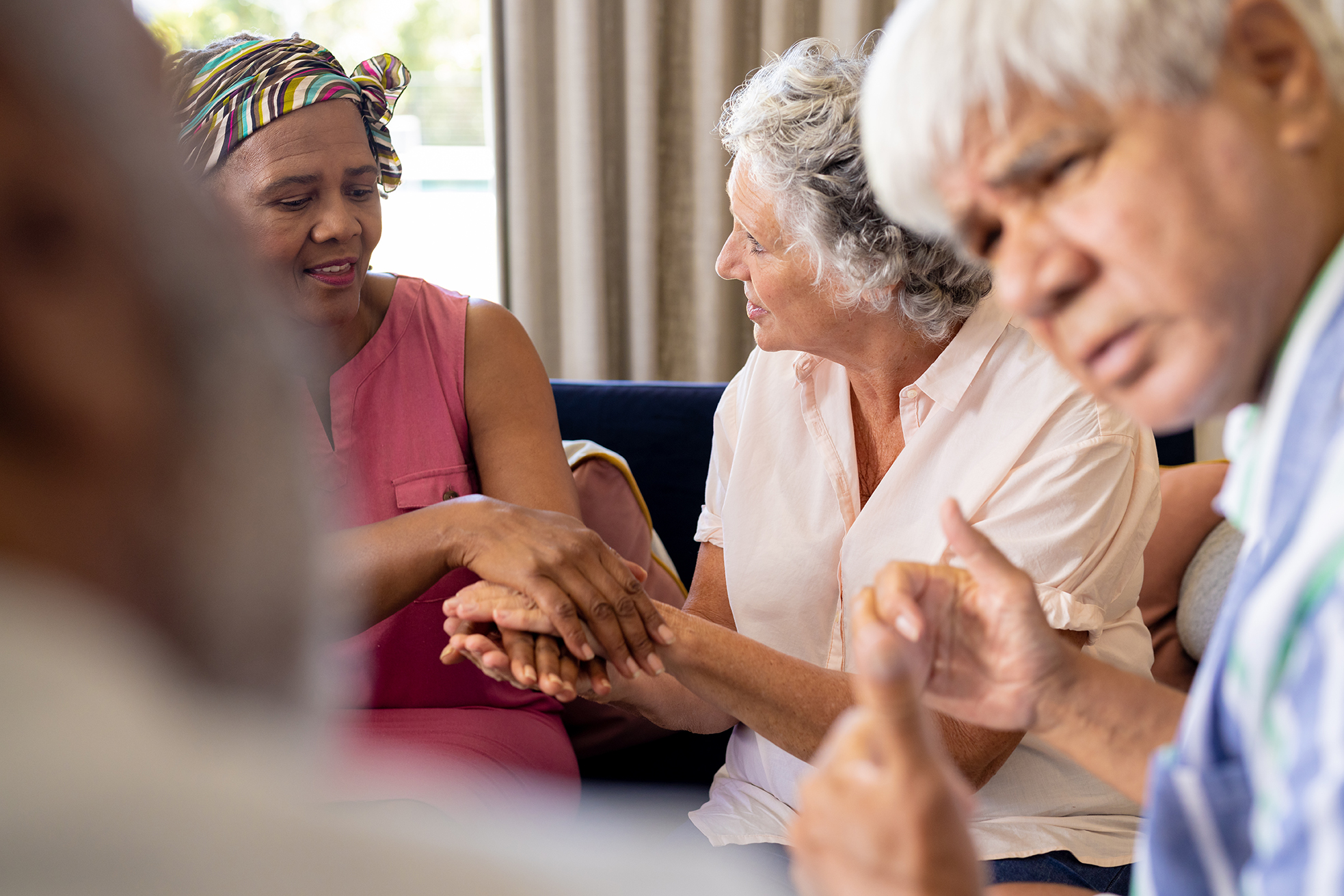 Senior diverse people sitting on chairs and talking and holding